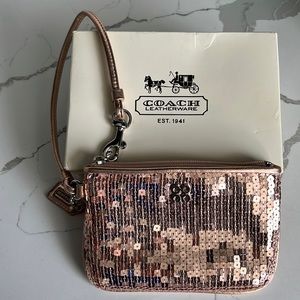 Coach rose gold sequinned wristlet